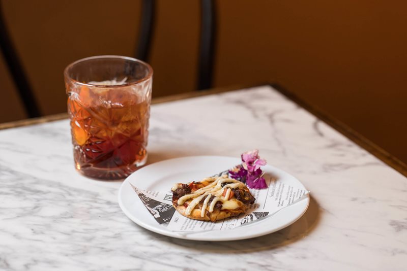 Davidson Plum Negroni and Coat of Arms Pizza Pocket